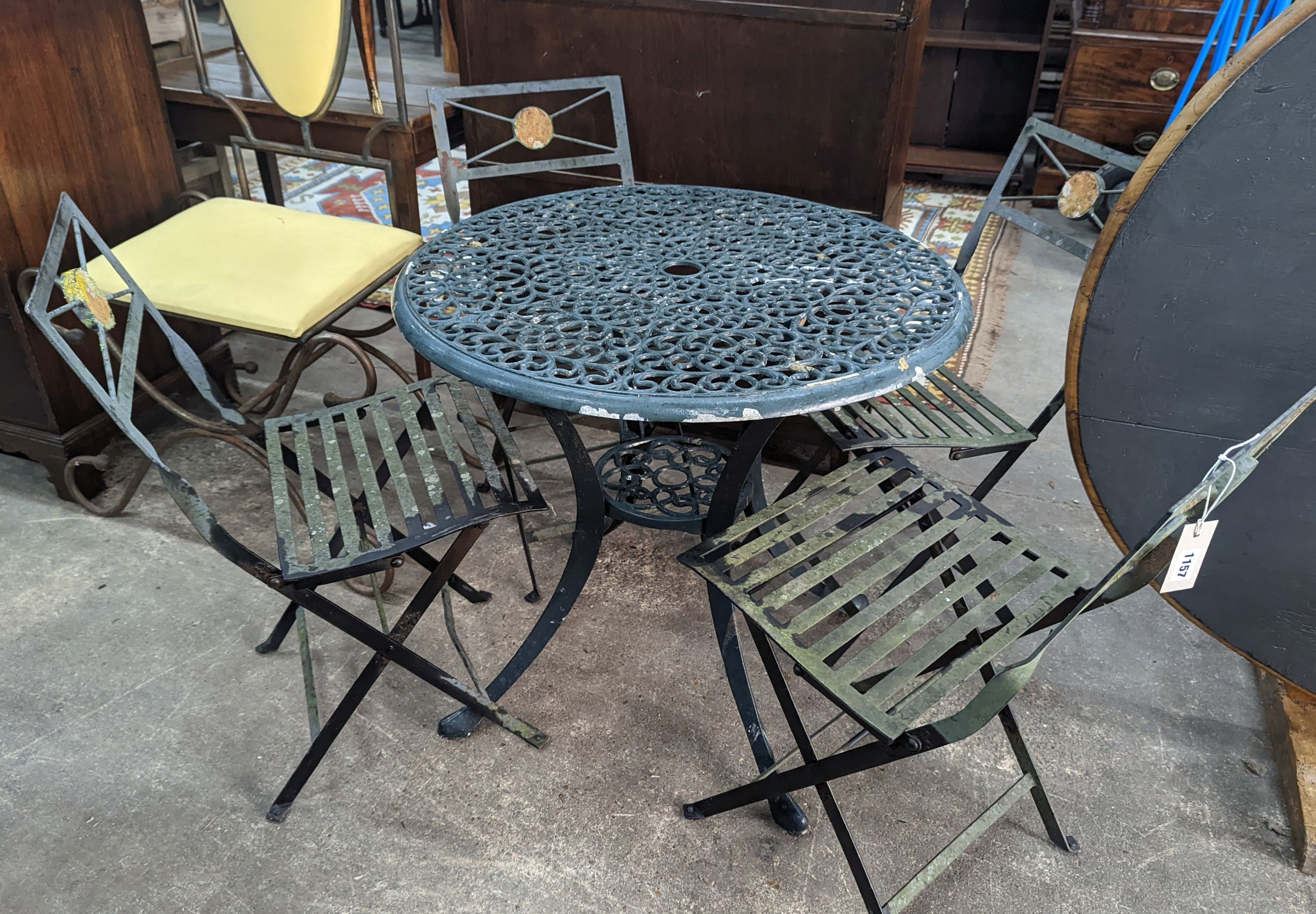 A circular aluminium garden table, diameter 74cm, height 72cm and four folding chairs